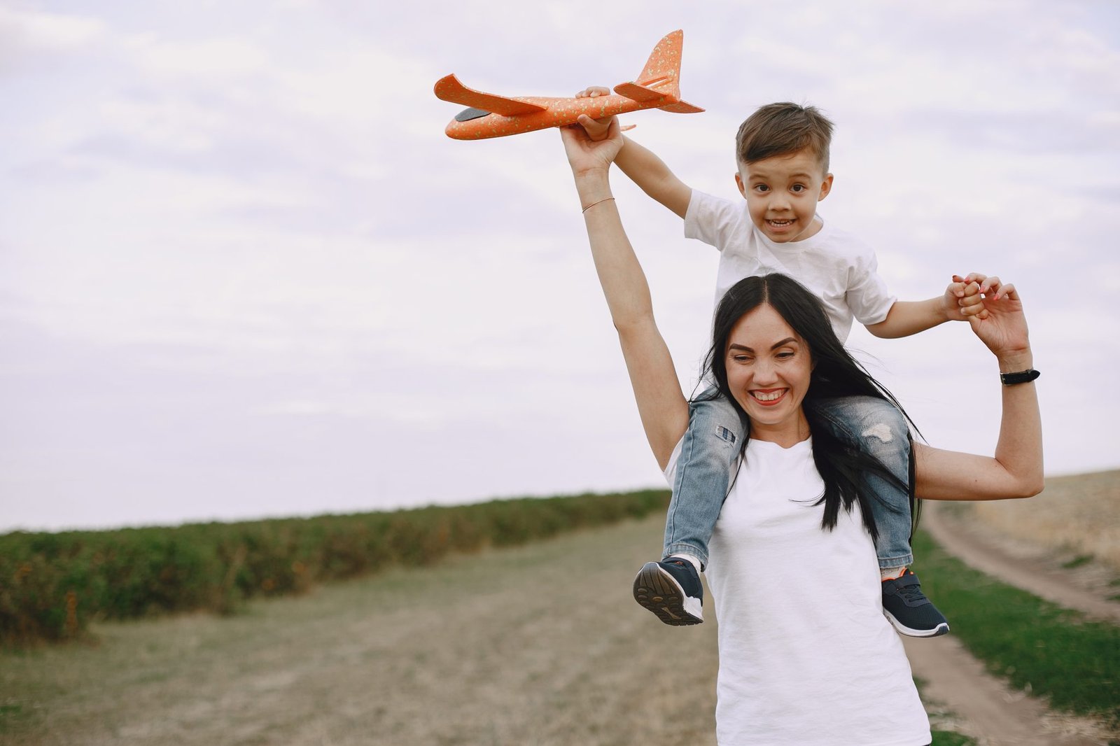 mother-with-little-son-playing-with-toy-plane-2048x1365